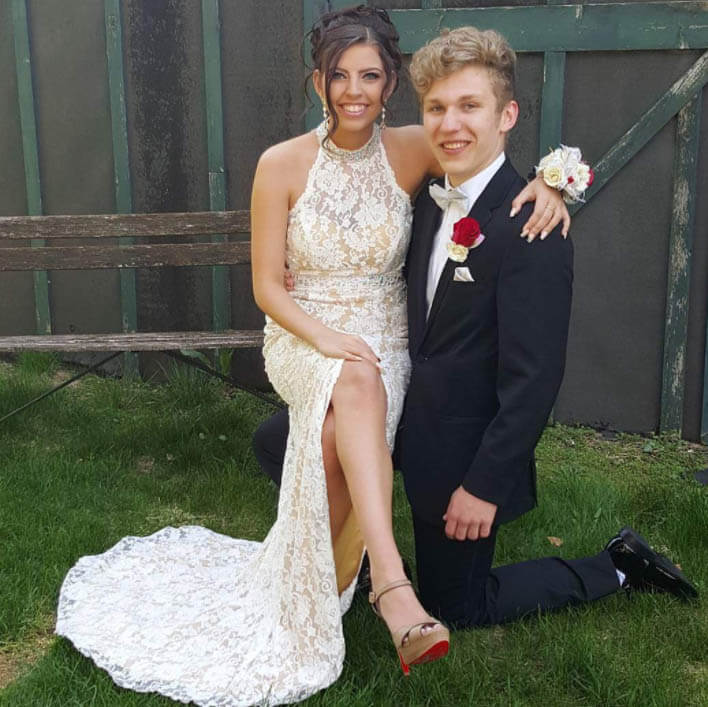 Сouple wearing a white gown and a black suit